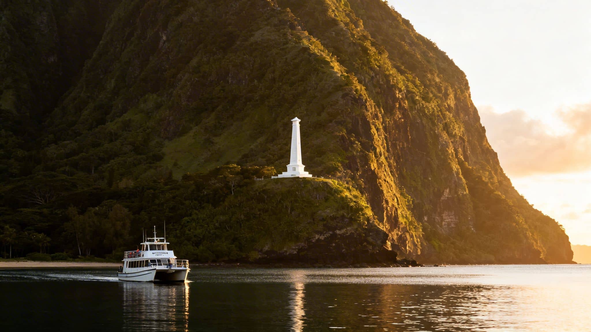 A boat glides past a white monument on a green cliffside bathed in golden sunset light.