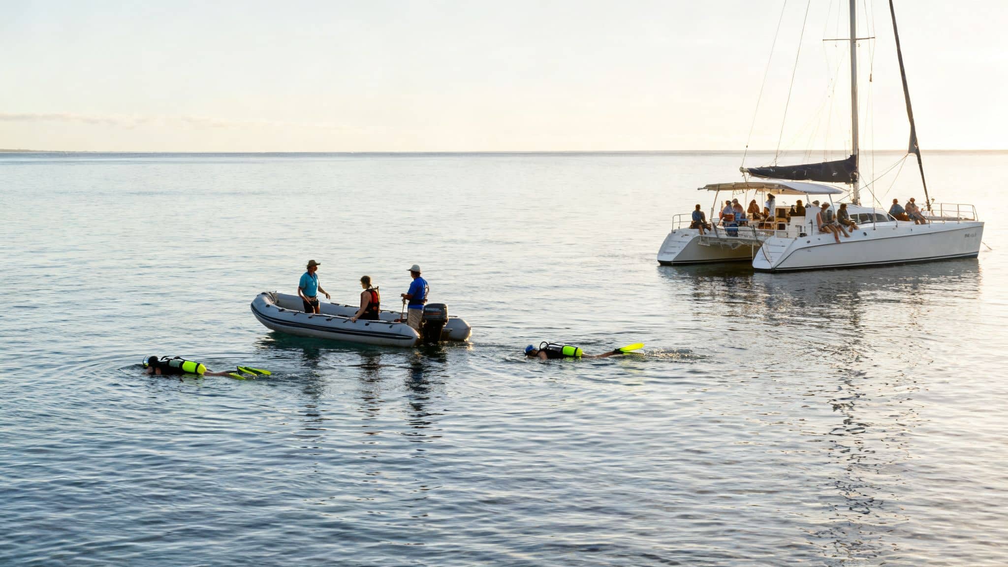 A vibrant scene of people snorkeling, diving, and relaxing on boats in the ocean.