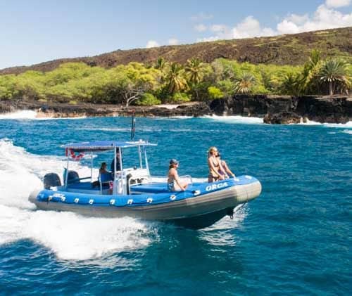 Guests riding the RHIB at speed along the lava coastline